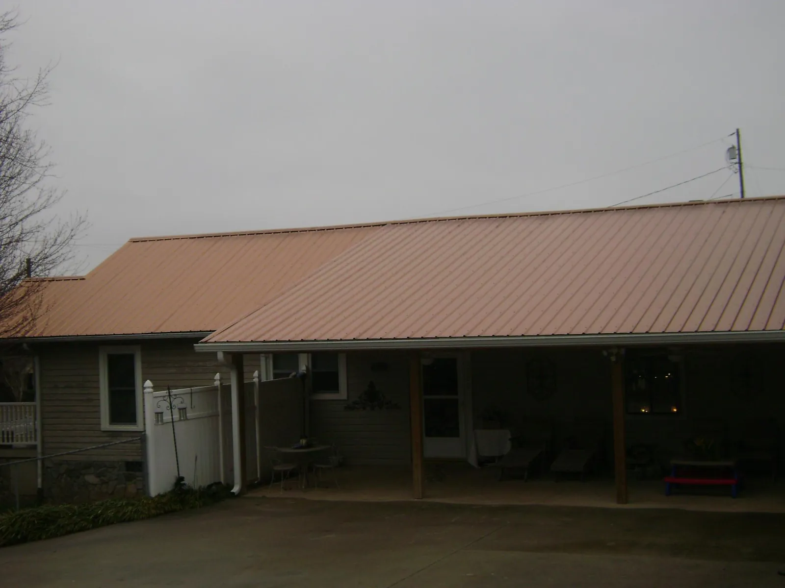 Copper toned metal roof over a wide covered patio in Piermont